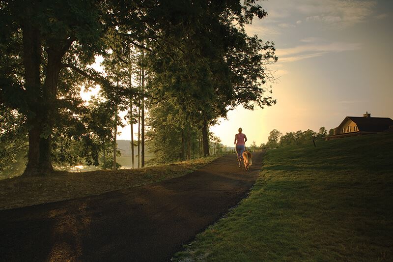 Running along trail at sunrise in Sterling on the Lake