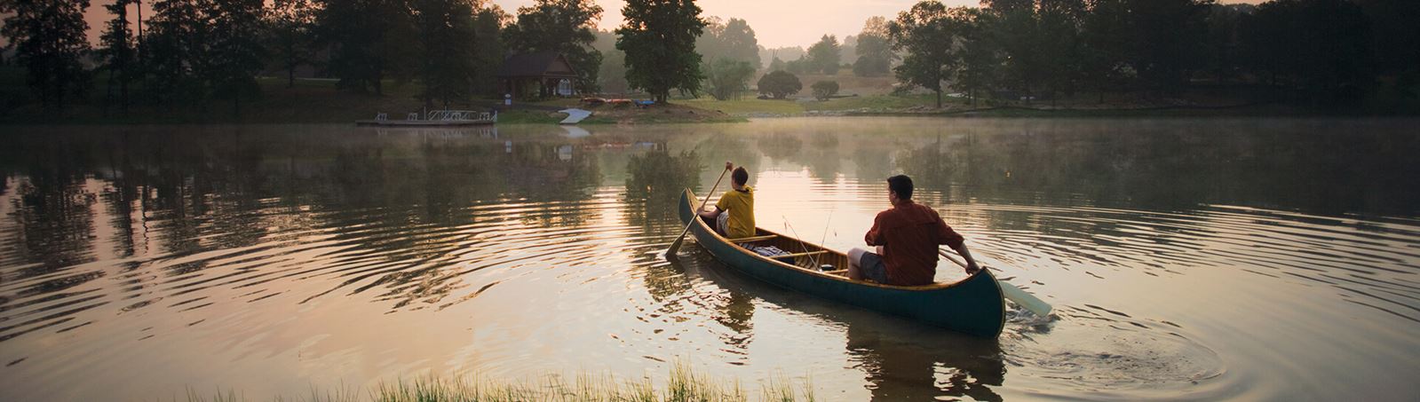 Father and son canoeing at dawn on Lake Sterling
