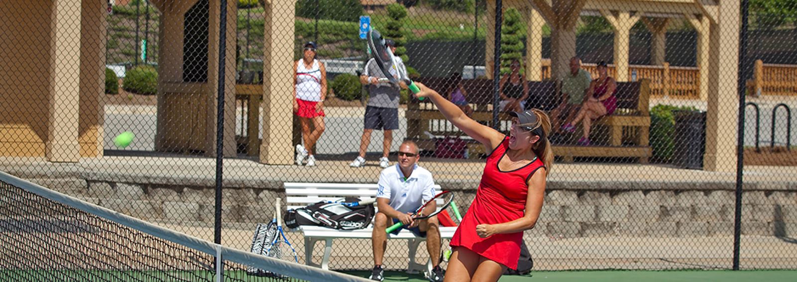 Women playing tennis at Sterling on the Lake
