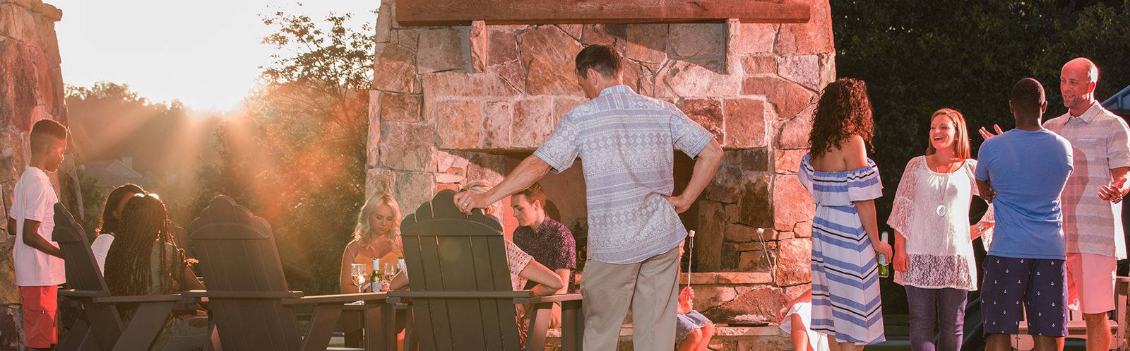 Gathering of Sterling on the Lake residents by the firepit amenity.