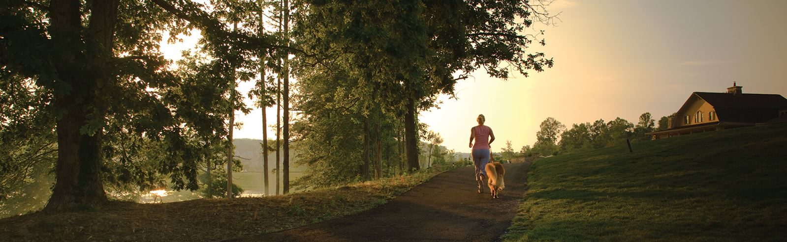 Woman running along trail at dawn in Sterling on the Lake.