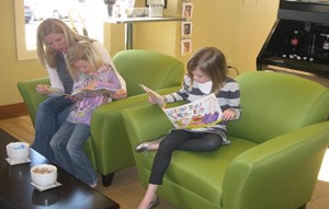 Girls reading with their mom in the Spout Springs Library.