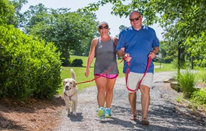 Couple with dog on walking trails around Lake Sterling