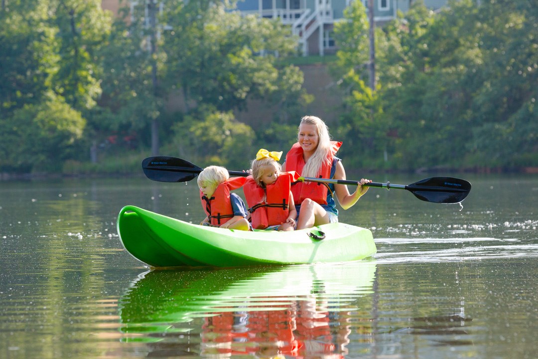 Mom and kids in kayak at Sterling on the Lake