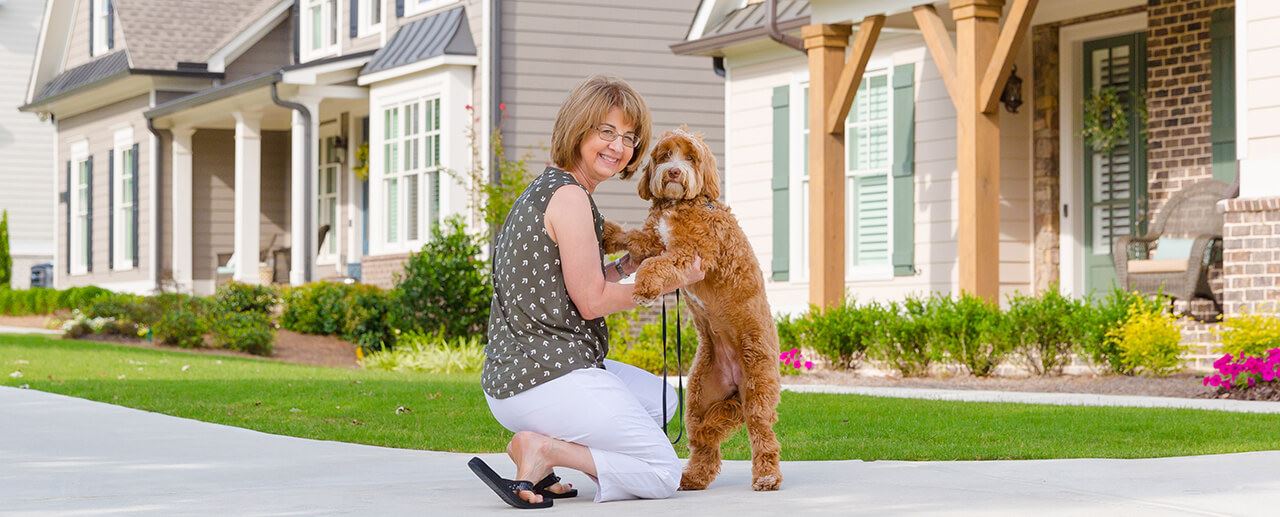 Joan with her puppy outside of her home in Sterling on the Lake.