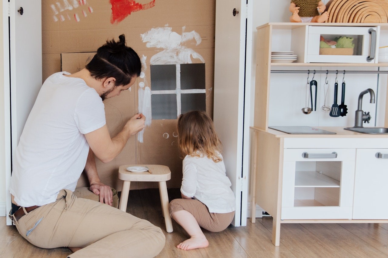 Dad and daughter building a play fort