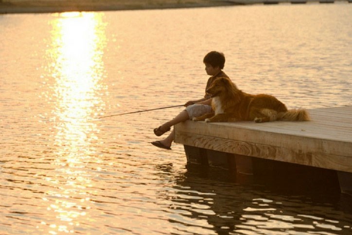 Boy and his dog fishing in Lake Sterling