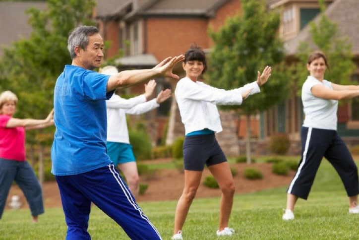 Group practicing Tai Chi on event lawn