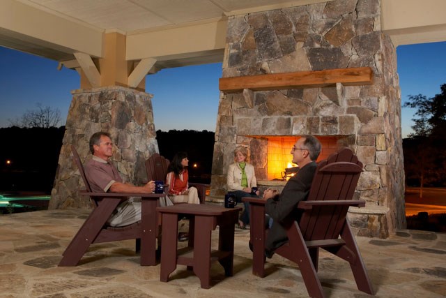 Residents enjoying quiet gathering by the firepit amenity.