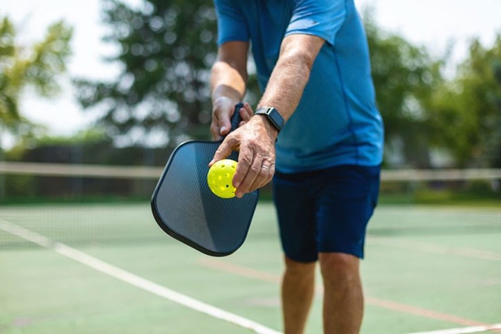 Serving up at Pickleball game in Sterling on the Lake.